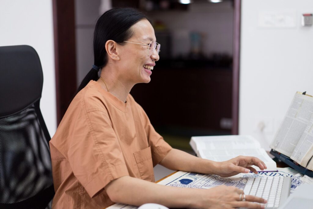 A smiling woman at a computer